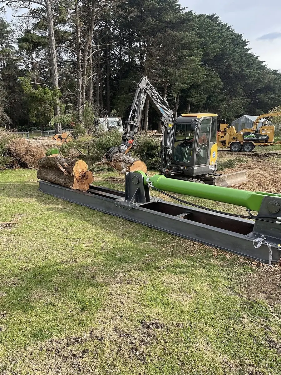 Excavator and plant working alongside a log trailer