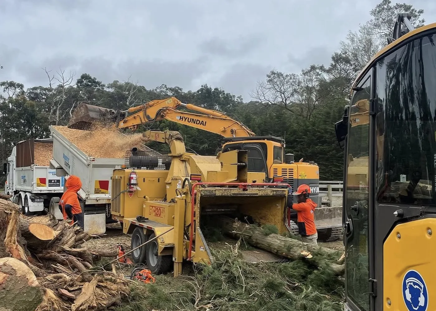 The Granite Group crew working with a chipper, tipper and excavator on a clearing job